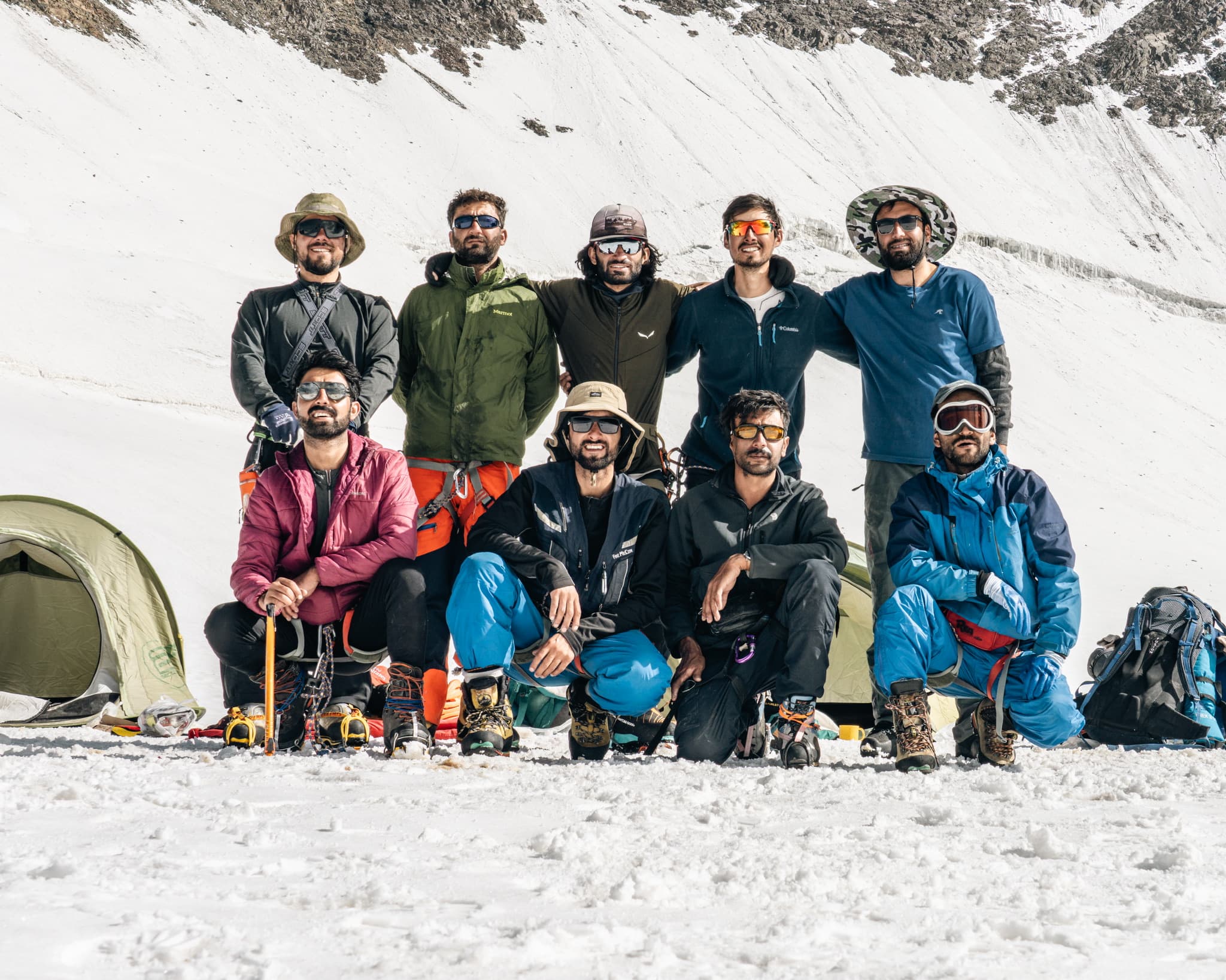 Expedition team gathered at a high-altitude base camp in Pakistan